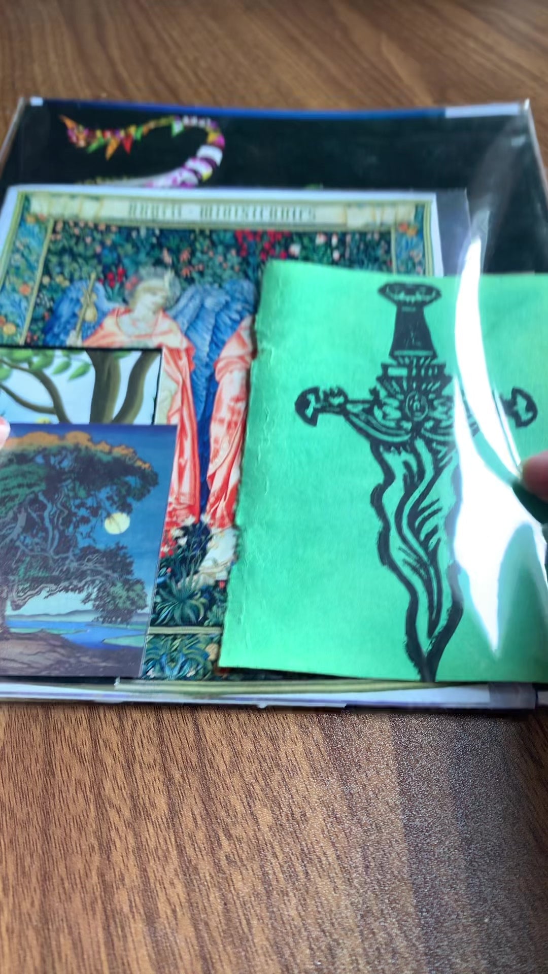 A flip-through video of the contents of an example Ephemera Mystery pack, containing various sizes of paper, art prints, and floral patterned pieces.