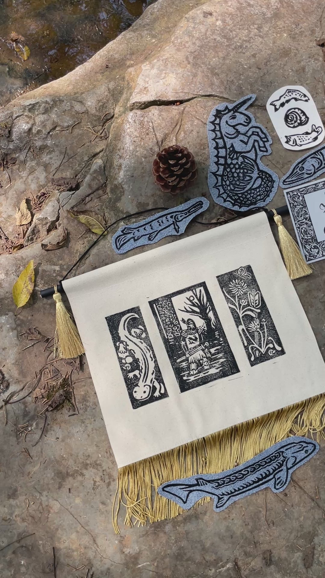 A collection of linocut printed art, iron-on patches, and accessories inspired by the creatures of the Green River.